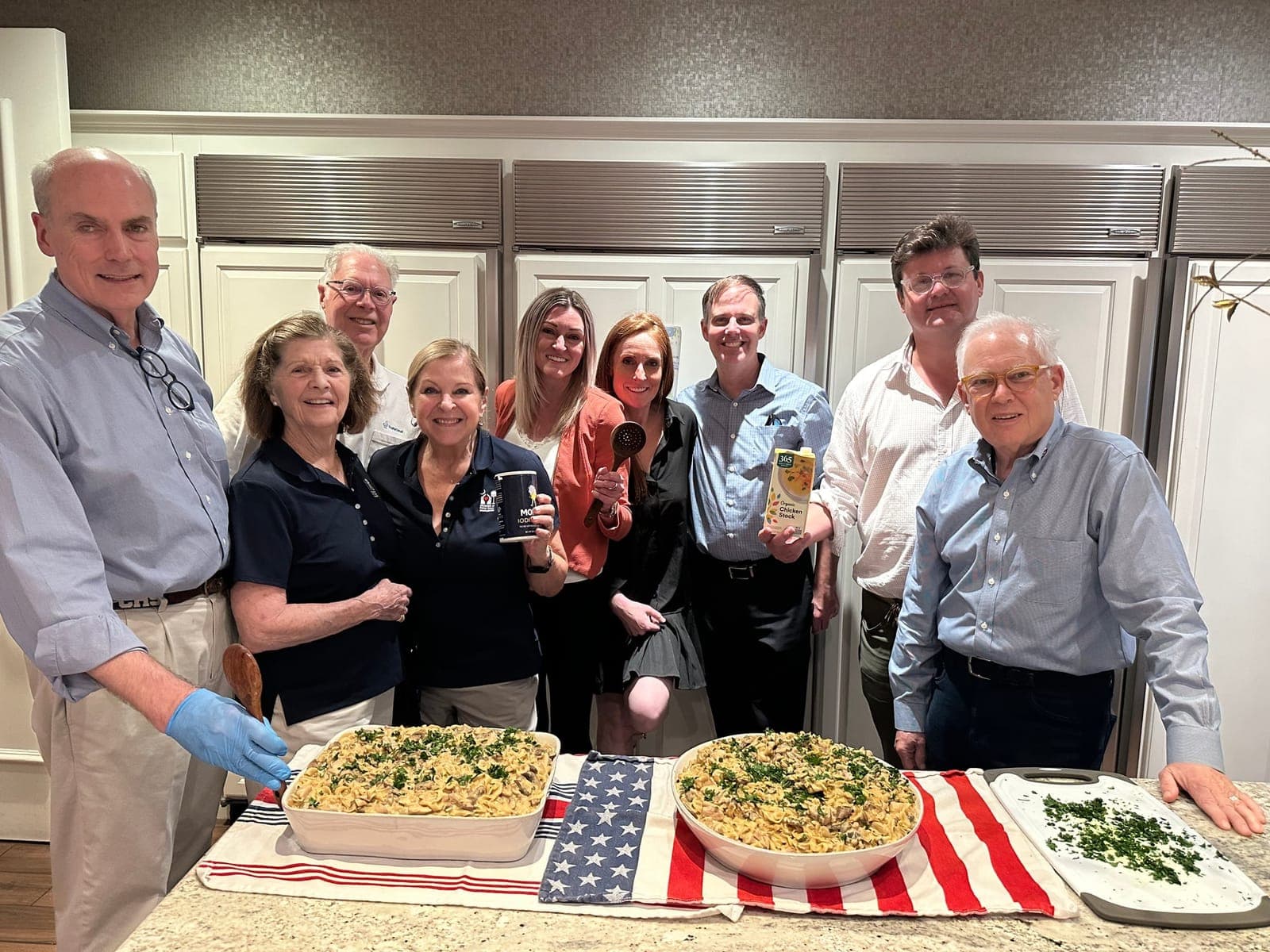 Order of St. John volunteers gathered in the Fisher House kitchen around two large dishes of chicken stroganoff