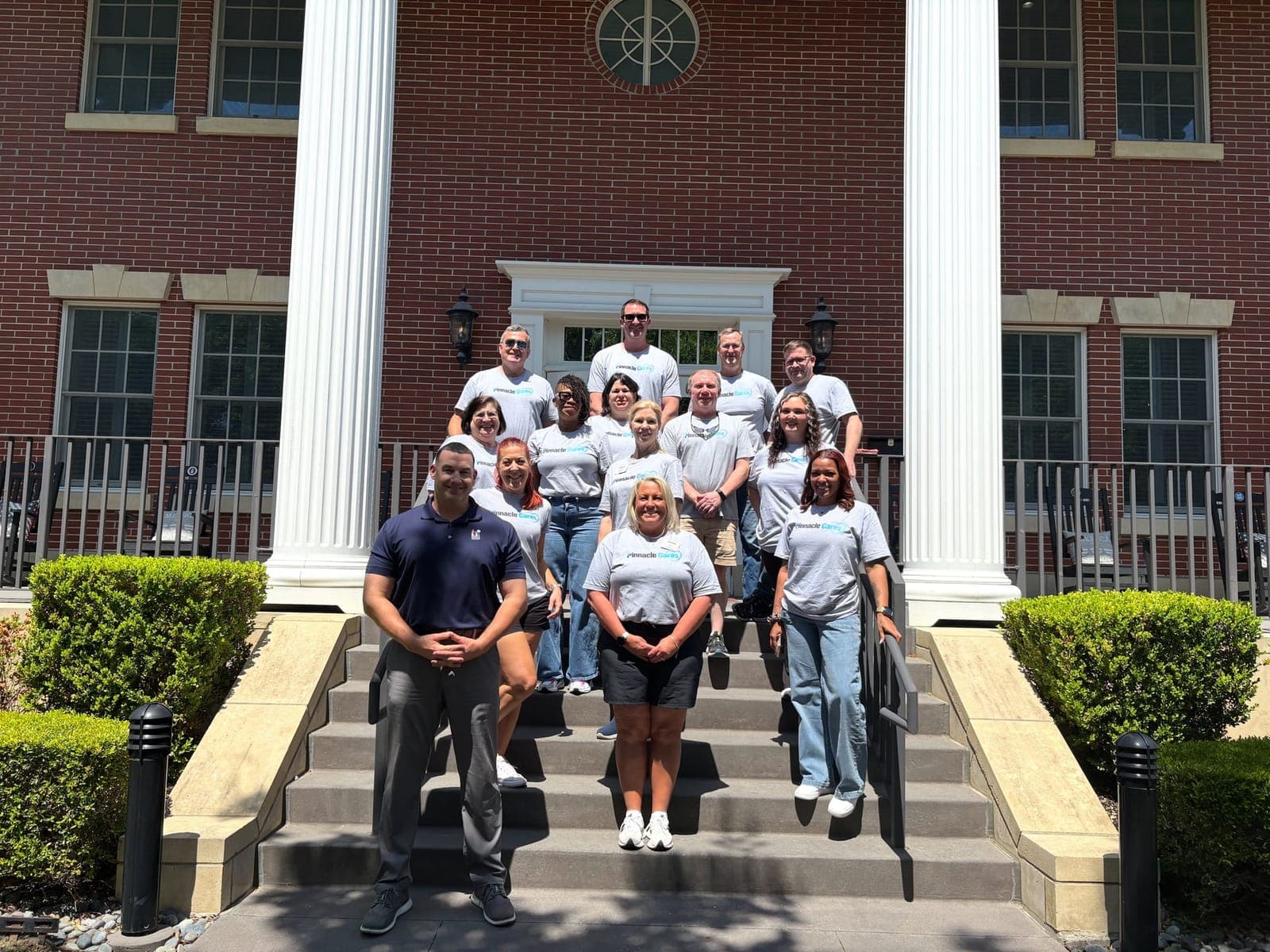 Pinnacle Financial Partners volunteers posing on the steps of the Charleston Fisher House